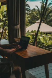 Remote work setup in Bali with a tropical view from a wooden desk